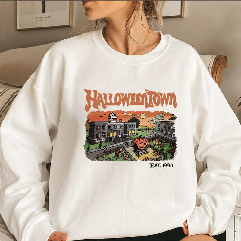 Person wearing a white sweatshirt with 'Halloweentown' graphic design.
