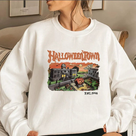 Person wearing a white sweatshirt with 'Halloweentown' graphic design.